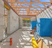 Construction of a family house in Marcelová with a roof structure and building material.
