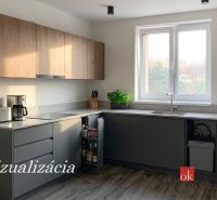 A kitchen in a one-room apartment with a wooden decor floor and a kitchen unit.