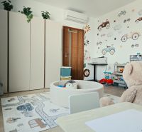 Children's room in a 4-room apartment with colorful furniture, wall decorations, and a wooden decor floor.