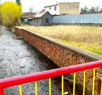 Image from Jarková Street, Košice - Šaca district, with a stream and adjacent lands.