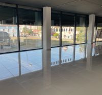 Large commercial spaces with glass walls and shiny floors.