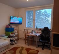 Children's room with a bed, desk, and floor with wooden decor in a 3-room apartment.
