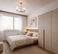 A bedroom with a bed, a wardrobe, and a wooden decor floor in a 2-room apartment.