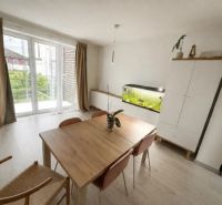 Dining area in a family house with a large window and an aquarium.