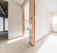A spacious interior of an unfinished 3-room apartment with large windows and a concrete ceiling.