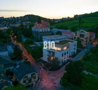 Evening view of Pod Strážami in Bratislava III with vineyards and 3-bedroom apartments.