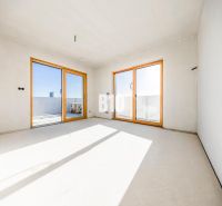 Spacious room with large windows and a view, bright walls, 3-room apartment.
