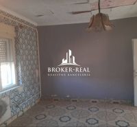 Interior in a family house with decorative wallpapers and ceramic flooring.