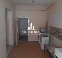 Interior of a family house with a kitchen, gas stove, and tiles.