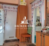 Interior of a family house with a kitchen, decorative curtains, and a decorated refrigerator.