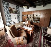 Living room in a family house with carpets and a wooden living room set.