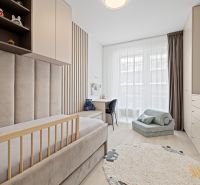 Children's room in a 3-room apartment with a bed, carpet, and shelves with toys.