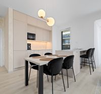 A kitchen in a 3-room apartment with white cabinets and a wood-patterned floor.