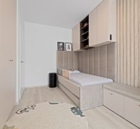 A children's room with storage cabinets and a bed tastefully matches in a three-room apartment.