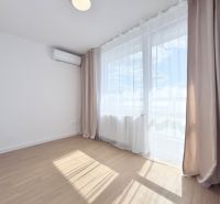 A room with a wooden decor floor and air conditioning in a 3-room apartment.
