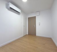 Interior of a 3-room apartment with wood-patterned flooring and air conditioning.