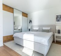 Bright bedroom in a family house with a large bed and a wardrobe.