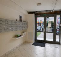 Entrance hall of a 3-room apartment with mailboxes and glass doors.