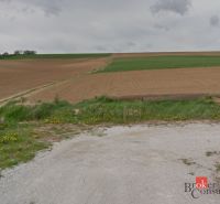 Land near Lužianky suitable for plots - housing, with a field and meadow in the background.