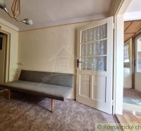 Bright room with a sofa and glass doors in a family house.