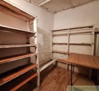 A shelf and a table in the interior of a family house, floor with wooden decor.