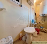 Bathroom with toilet and boiler in a family house.