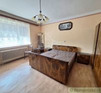 A bedroom in a family house with a wooden decor floor and stylish furniture.