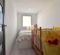 Children's room in a 3-room apartment with white walls and a crib.