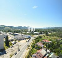 View of the landscape and buildings of Bytča from above, showing the road and buildings.