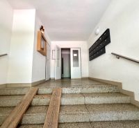The entrance hall in an apartment building with mailboxes and an elevator.