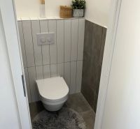 Bathroom in a 3-room apartment with storage space and decoration on the shelf.