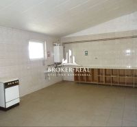Interior with kitchen area, white tiles, and storage spaces in warehouses and halls.