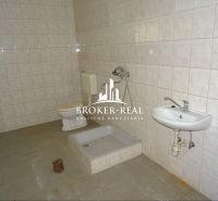 Bathroom in warehouses and halls with tiles, shower, and toilet.
