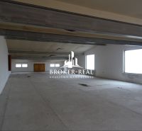 Spacious room of warehouses and halls with windows on a white wall and steel beams.