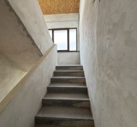 Concrete staircase leads to the window, OSB board ceiling, Family house.