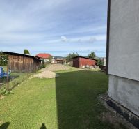 A grassy yard at a family house in Plavnica with a view of further development.