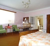 A room in a family house with furniture and a bed, a floor with carpet decor.