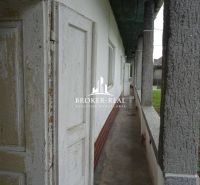 In Černochov, a family house with a long corridor balcony and columns.