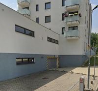 Building with a garage on Švermova Street in Banská Bystrica, parking bollards.