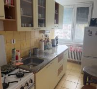 A kitchen in a 2-room apartment with a kitchen unit and appliances.