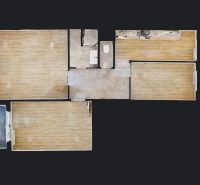 Floor plan of a 3-room apartment with wood-patterned flooring and basic furnishings.