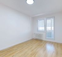 A bright room with a wooden decor floor in a 3-room apartment.