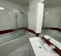 A bathroom with a bathtub and a showerhead in a 3-room apartment.