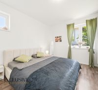 Bedroom with a bed and wardrobes, wooden decor flooring, 3-room apartment.