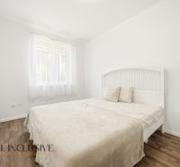 Bright bedroom in a 3-room apartment with a bed and wood-decor flooring.