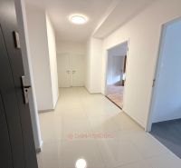 A bright hallway in a 2-room apartment with ceramic flooring and white walls.