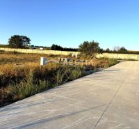 Plots - housing in Rovensko with a concrete area surrounded by nature and fencing.