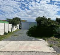 Industrial facility in Záhrady on Galvaniho, Bratislava - Ružinov, surrounded by greenery and concrete walls.