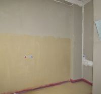 Empty room in a 2-room apartment with basic water and electricity connections.