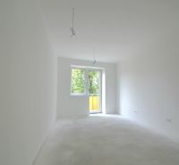 Empty room with white walls and floor in a two-room apartment.